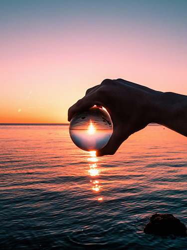 nature crystal ball photography of golden hour sky