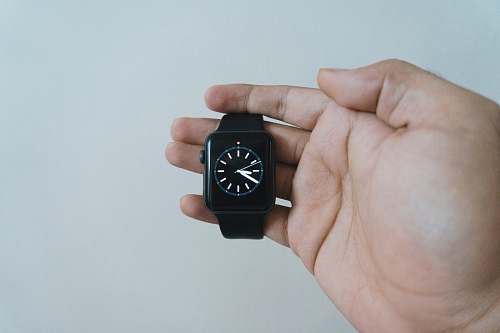 person person holding apple watch at 8:40 human