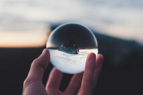 human person holding glass ball person