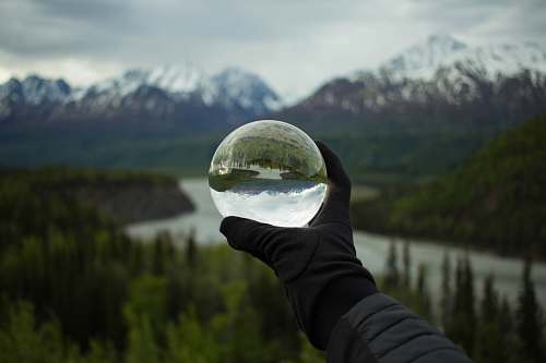 human person holding glass globe person