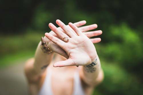 person selective focus photo of person's hand with gold-colored ring in it ring