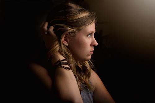 person shallow focus photography of person holding her hair human