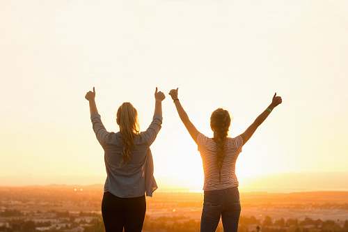 human two woman standing near field person