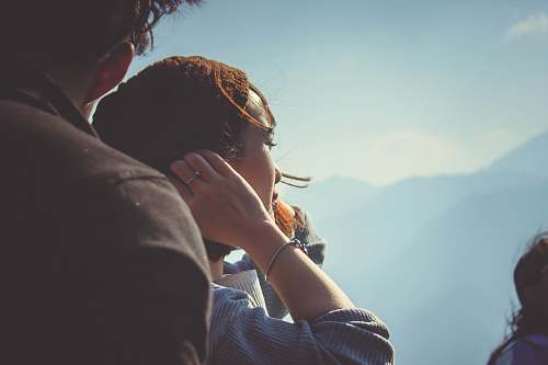 person woman beside man holding her hair at daytime human