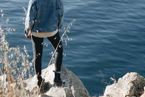 person woman standing on cliff human