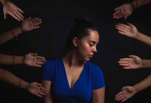 person woman wearing blue V-neck short-sleeved top hands