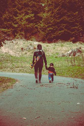 human adult and toddler walking on road apparel