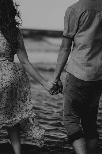 human couple at beach black-and-white