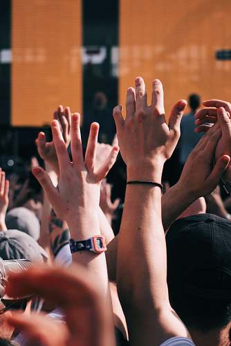human crown of people raising hands finger