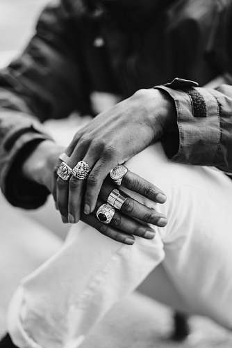 human graayscale photography of man wearing rings black-and-white