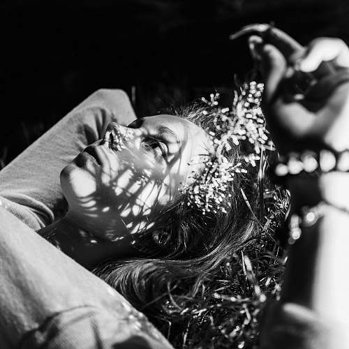 people grayscale photo of woman smoking cigarette black-and-white