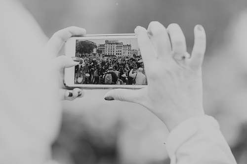 human greyscale photography of person taking photo black-and-white