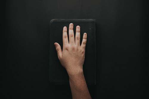 hand left human hand on black book wrist