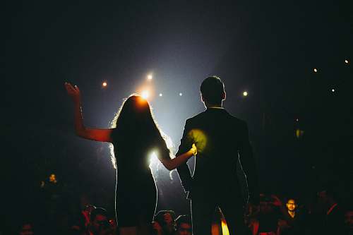 human man and woman on stage flare