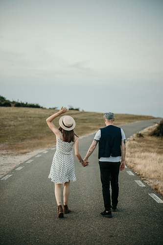human man and woman walking on road apparel