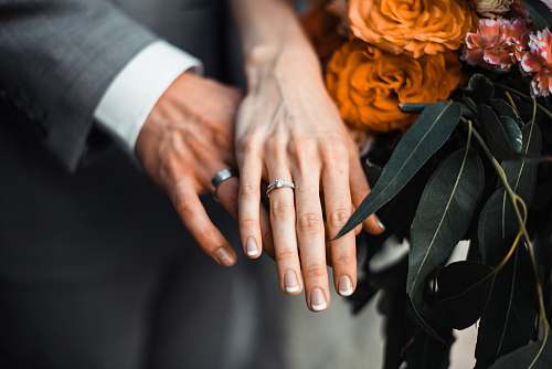 human man and woman wearing silver-colored rings people