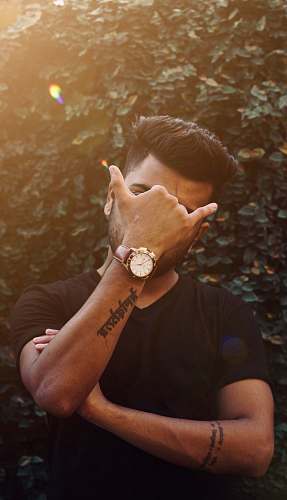 human man covering his face skin