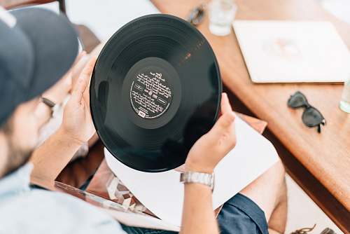 human man holding vinyl record people