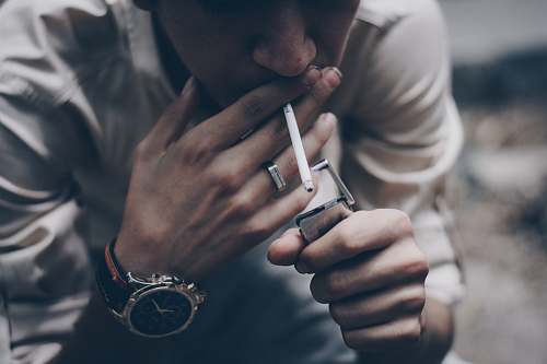 human man lighting cigarette stick people