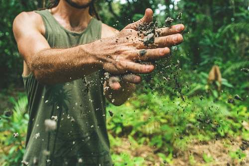 human man playing with sand dirt