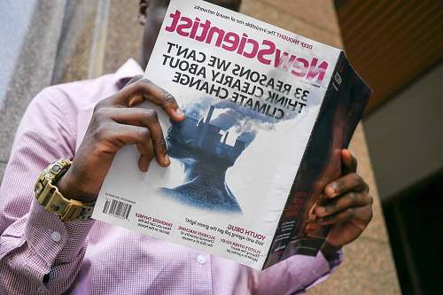 human man reading New Scientist book people