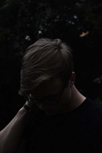 people man wearing black shirt and eyeglasses with left hand on neck human