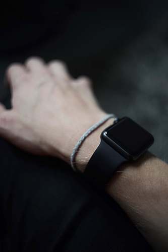 human man wearing space gray Apple Watch with black Sports Band people