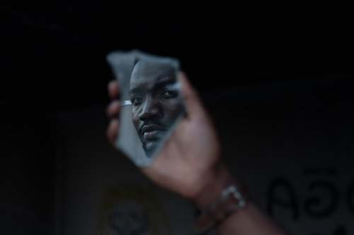 human man's face reflected on mirror finger