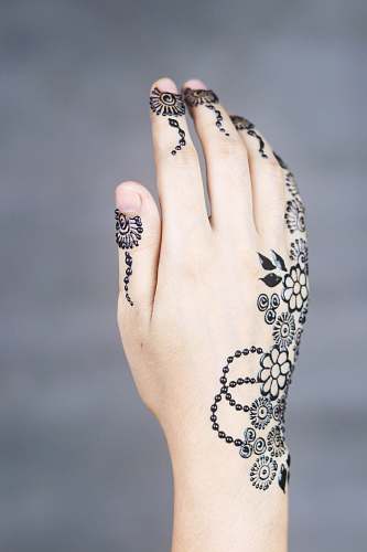 human mendhi tattoo on leaf hand skin