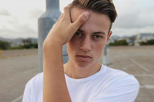 human men's white crew-neck top close-up photography face