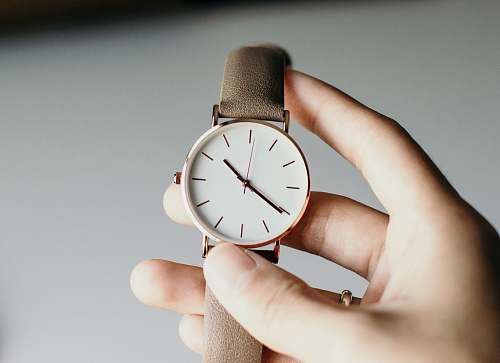 human person holding analog watch people
