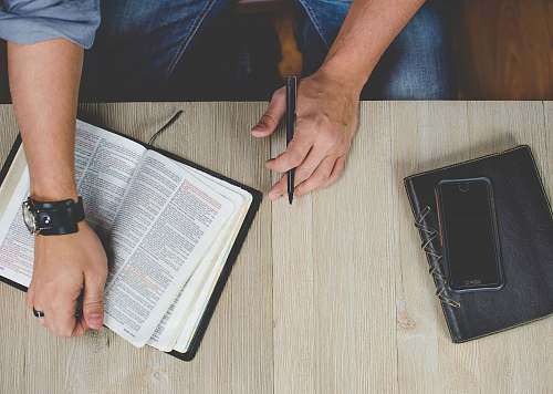 bible person holding bible with pen book