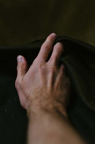 human person holding black textile finger