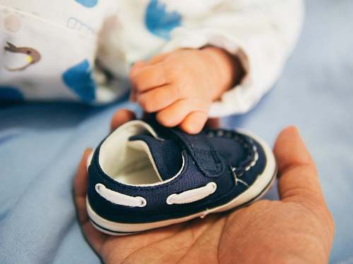 baby person holding blue boat shoe kid