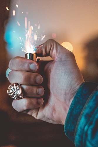 human person holding lighted lighter people