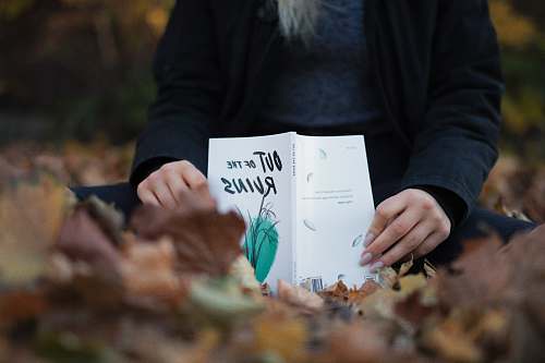 people person holding Out Of The Ruins book human
