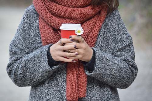 people person holding red and white disposable cup human
