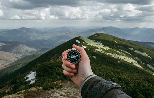 human person holding silver compass people