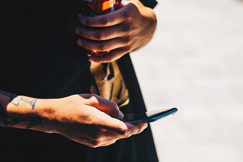 human person holding smartphone finger