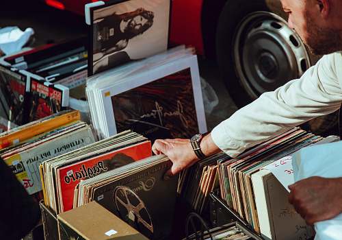 music person holding vinyl records vintage