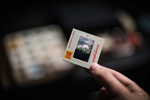 human person holding white Kodachrome box kodachrome
