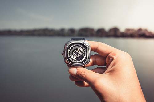 human person holding wristwatch people