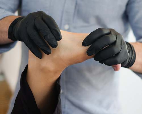 human person massaging other person's foot arm