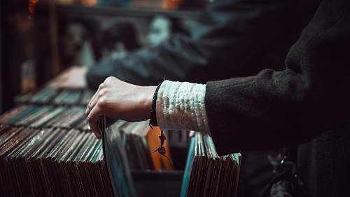 record person picking up the music record music