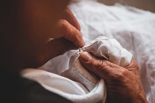 human person sewing shirt finger