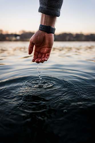 water person touching body of water outdoors