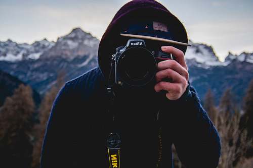 camera person using Nikon DSLR camera italy