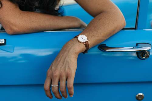 human person wearing gold-colored watch arm