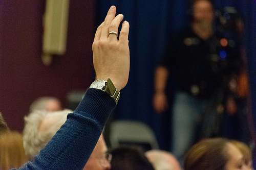 human person wearing silver-colored ring rising above finger