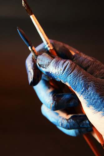 human person with stained hand holding paintbrush people